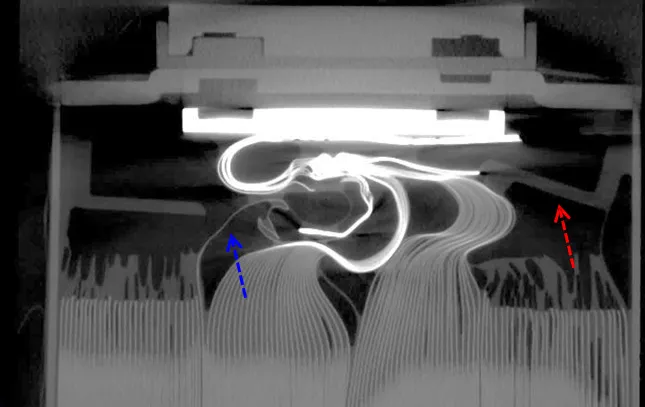 CT slice showing folded tab foils inside a prismatic battery cell